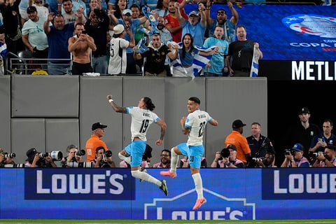 Darwin Nunez, left, celebrates after scoring Uruguay's 2nd goal